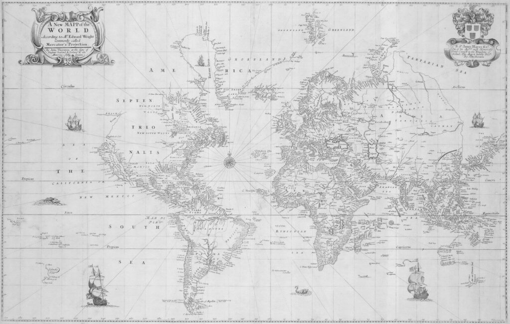 An old world map with ships and cartouches